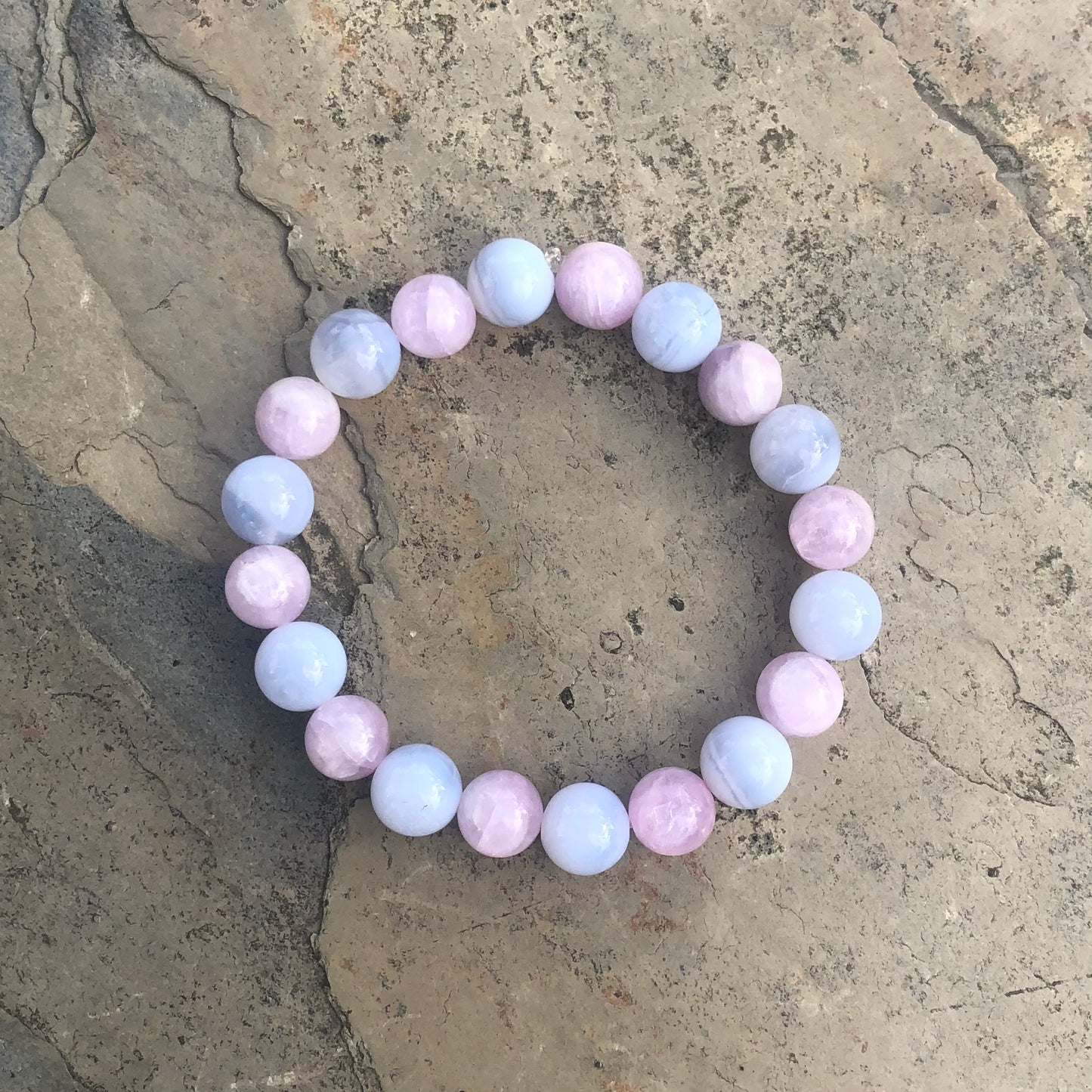 Bracelet made from soft pink kunzite and pale blue lace agate beads, designed for calm, communication, and emotional wellness.