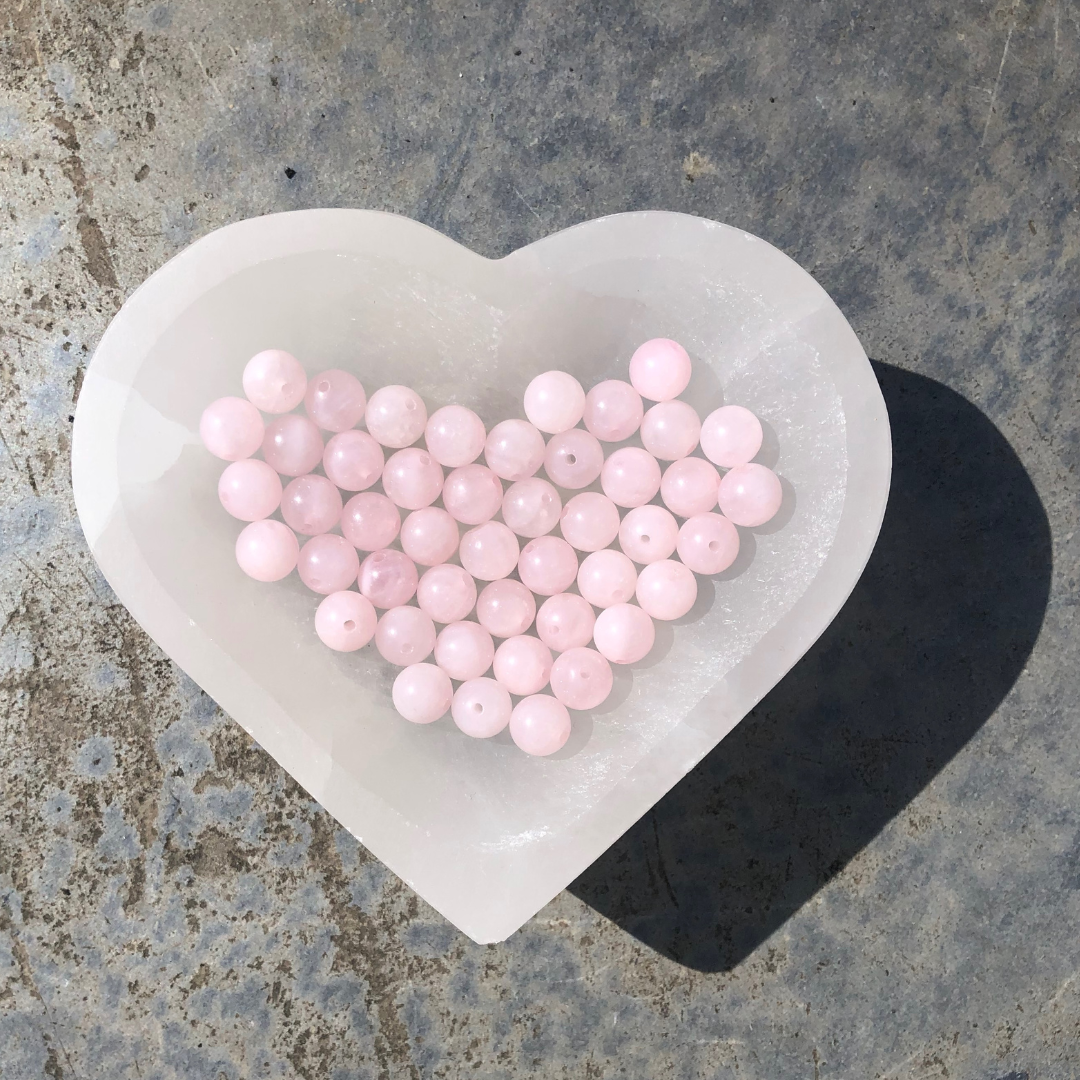 Feel Centred and Loved rose quartz bracelet with soft pink polished beads, designed to promote love, calm, and emotional balance. Handmade in New Zealand.