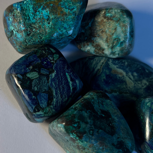 Tumbled shattuckite stone with vibrant blue and green patterns, known for enhancing communication, emotional balance, and intuition.