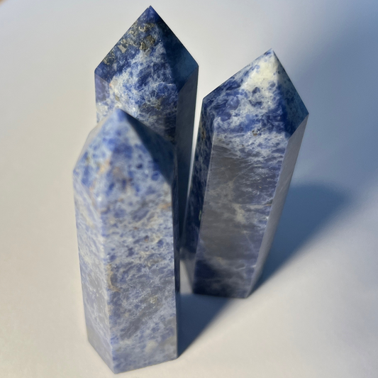 Blue and white sodalite crystal mini tower, known for enhancing communication, clarity, and emotional calm.