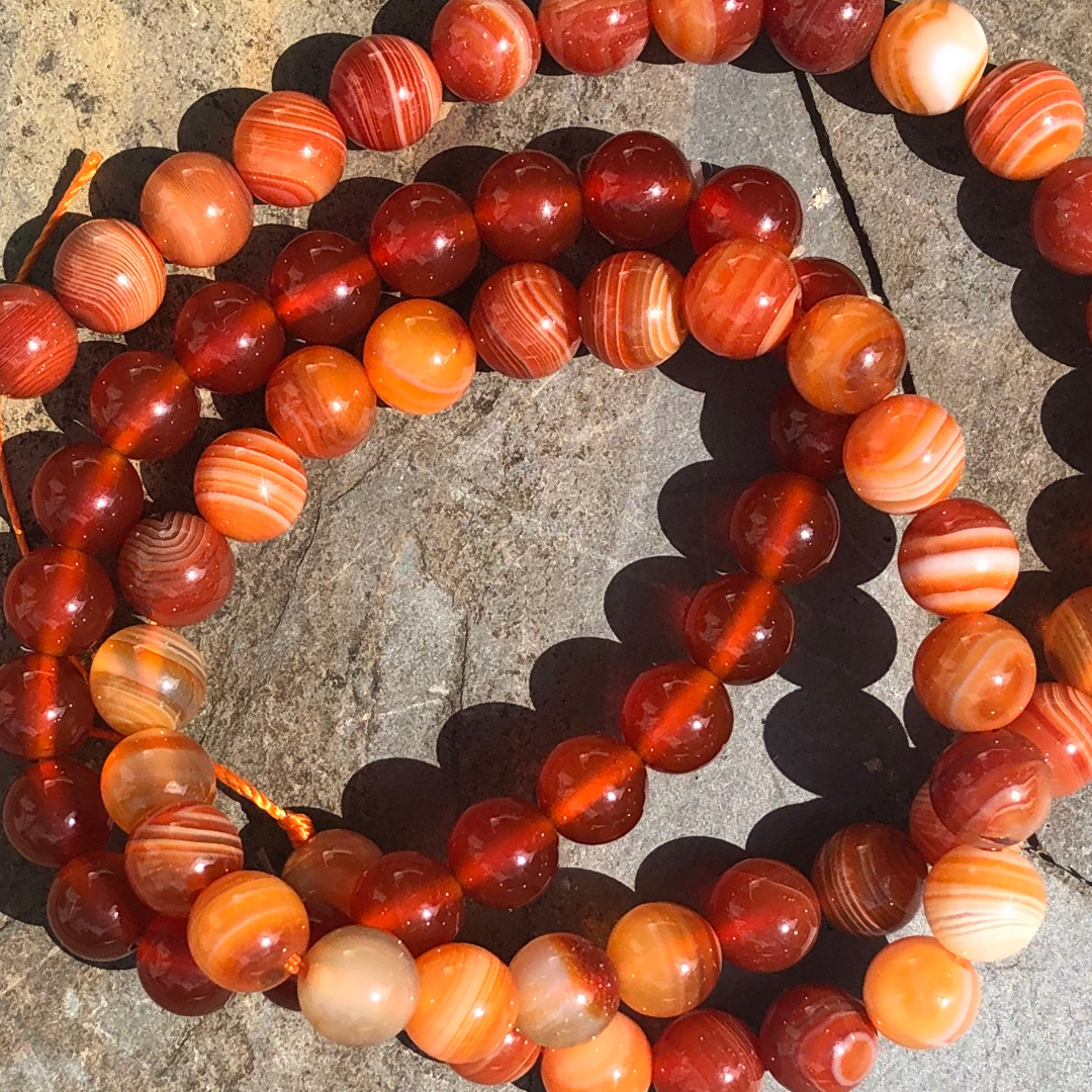 Creative Carnelian bracelet with rich orange-red polished beads, designed to boost creativity, motivation, and emotional balance. Handmade in New Zealand.