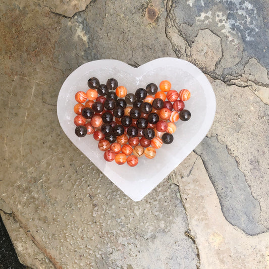 Carnelian and smoky quartz beaded bracelet symbolising grounding, energy, creativity, and protection.