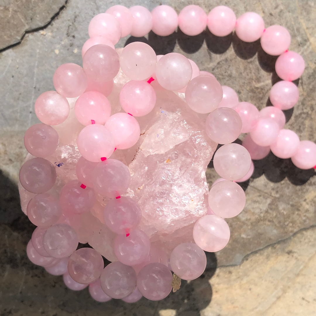 Feel Centred and Loved rose quartz bracelet with soft pink polished beads, designed to promote love, calm, and emotional balance. Handmade in New Zealand.